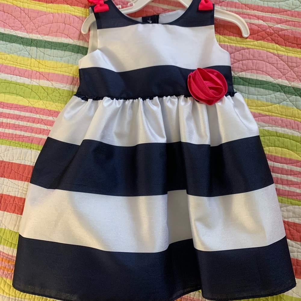 New with tags. Navy and white stripe with pink flower and bows.